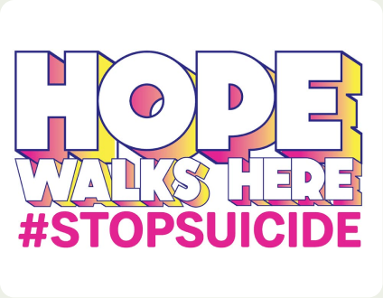 A hand-lettered sign reading &ldquo;Hope walks here &mdash; #StopSuicide&rdquo;